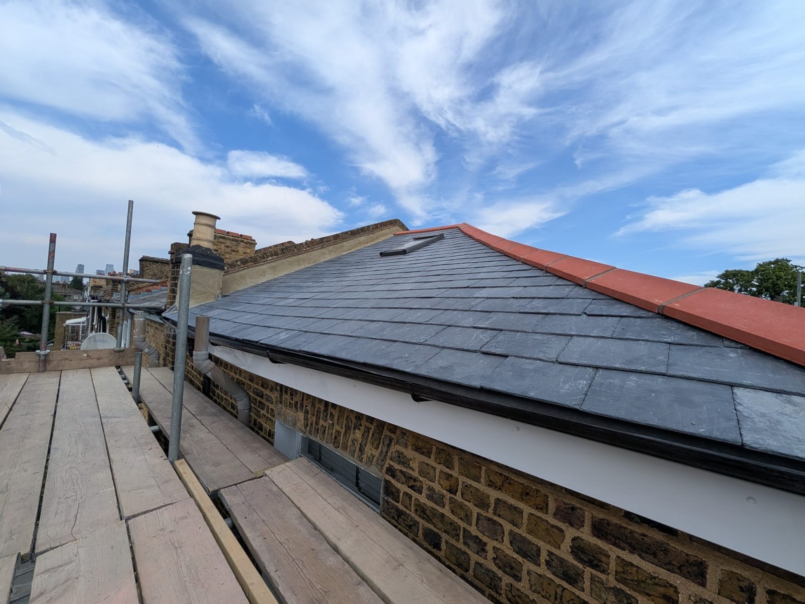 Clean natural slate roof slope free of moss after roof works
